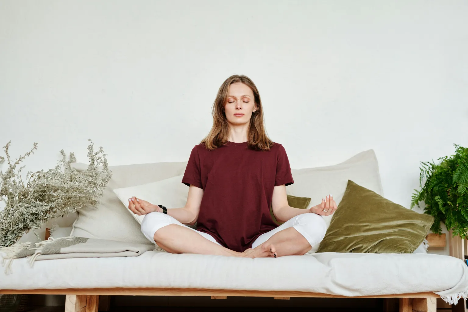 Person meditating relaxed on a sofa